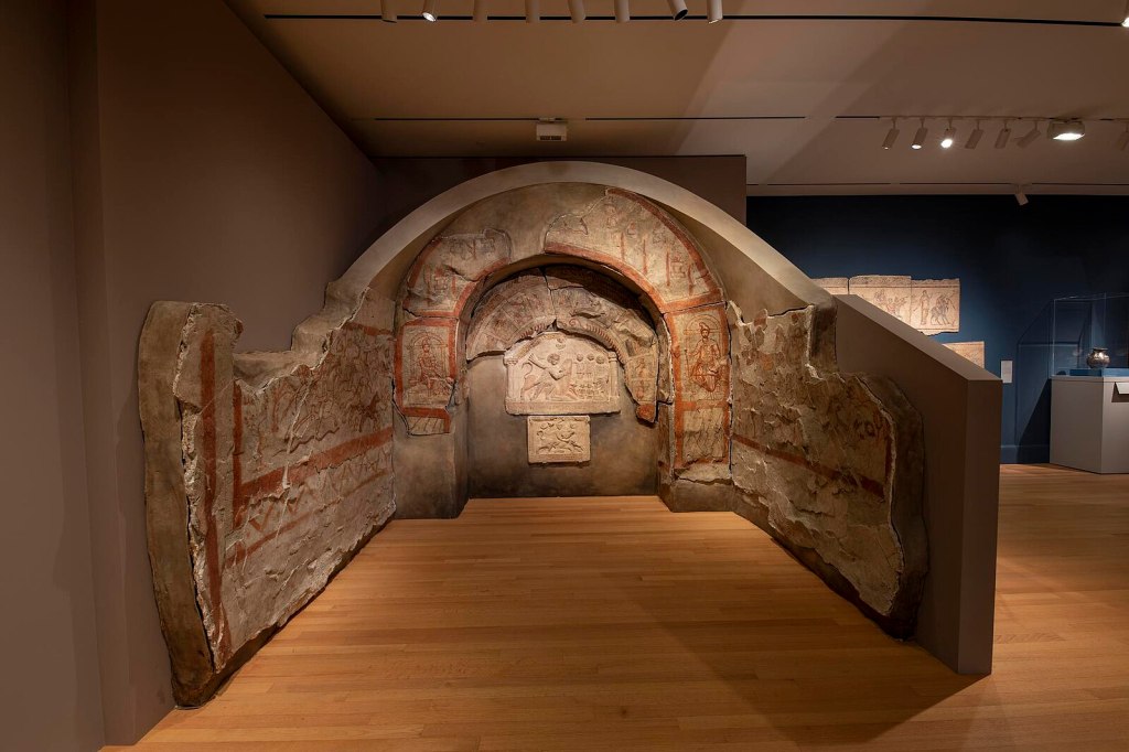 Mithraeum fresco from Dura-Europos showing Mithras killing a bull, flanked by torchbearers and surrounded by symbolic animals, painted in a Near Eastern style within a Roman frontier temple.