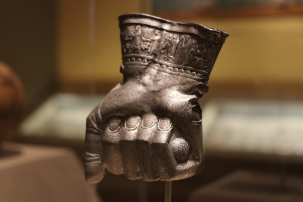 Hittite ceremonial drinking cup shaped like a human fist, made of silver, with detailed relief figures along the sleeve, from Central Turkey, likely used in rituals during the reign of Tudhaliyas III (c. 1400–1380 B.C.). Silver Hittite objects like this are exceptionally rare and held ritual significance.