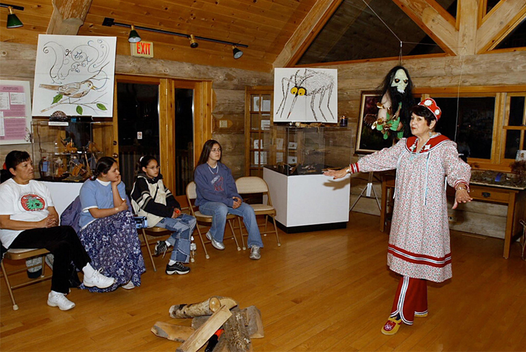 Oneida Nation community members engaging in oral storytelling, illustrating the role of elders passing down cultural tales and lessons through spoken tradition.