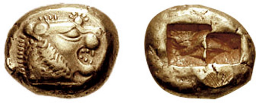 Close‑up photograph of an early Lydian electrum stater (coin) from the early 6th century BCE showing a roaring lion’s head on one side and characteristic punched marks on the reverse, illustrating one of the earliest forms of standardized coinage.
