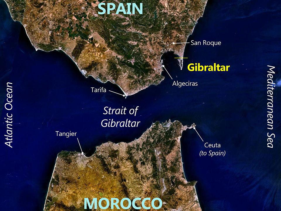 Annotated satellite view of the Rock of Gibraltar and the surrounding Strait of Gibraltar, showing the narrow waterway between southern Spain and northern Morocco with key geographic features labeled.