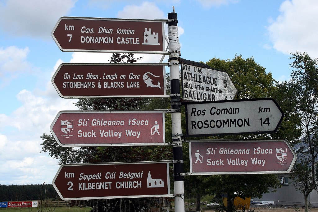 Bilingual road sign in Creggs, County Galway, displaying Irish (Gaeilge) alongside English.