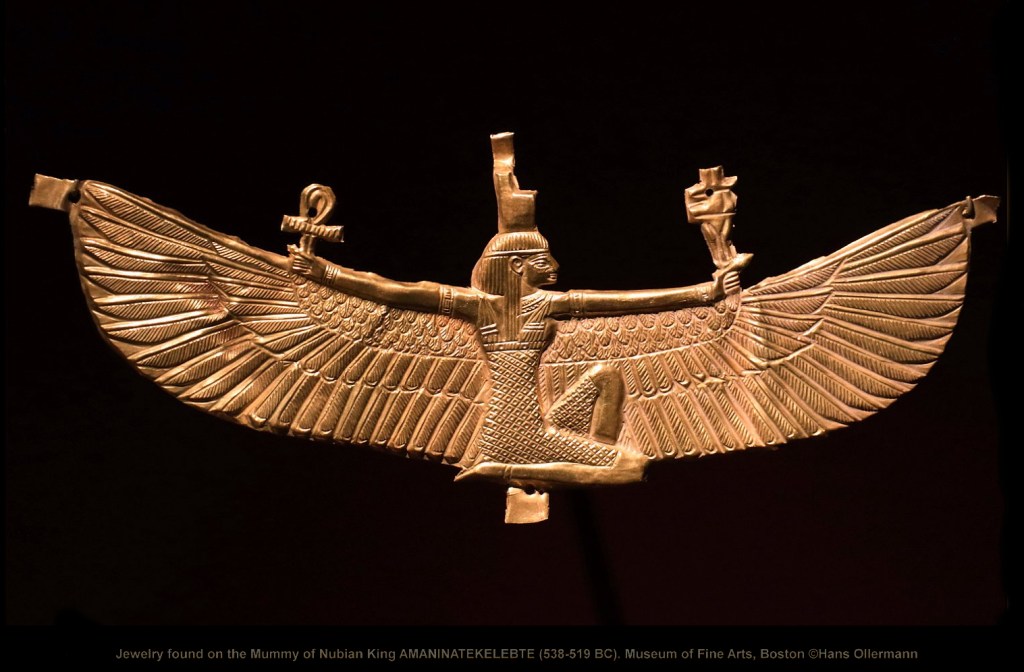 Gold and beaded royal jewelry from the burial of Nubian King Amaninatakilebte (538–519 BC), featuring layered collars, intricate pendants, and decorative motifs that reflect Nubian craftsmanship blending local styles with Egyptian symbols such as deities and hieroglyphs.
